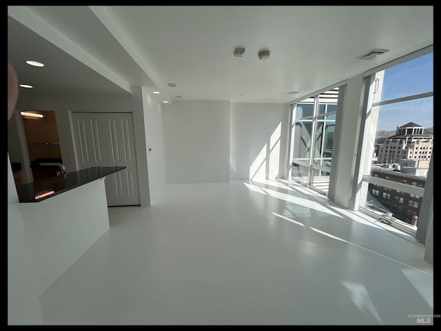 199 N Capitol Blvd, Boise, ID 83702 - unfurnished living room featuring finished concrete floors, a wall of windows, and a sink