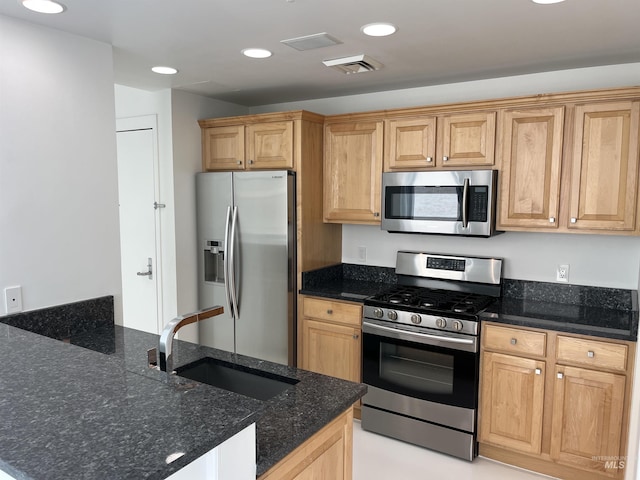 199 N Capitol Blvd, Boise, ID 83702 - kitchen featuring stainless steel appliances, a sink, recessed lighting, dark stone counters, and a peninsula