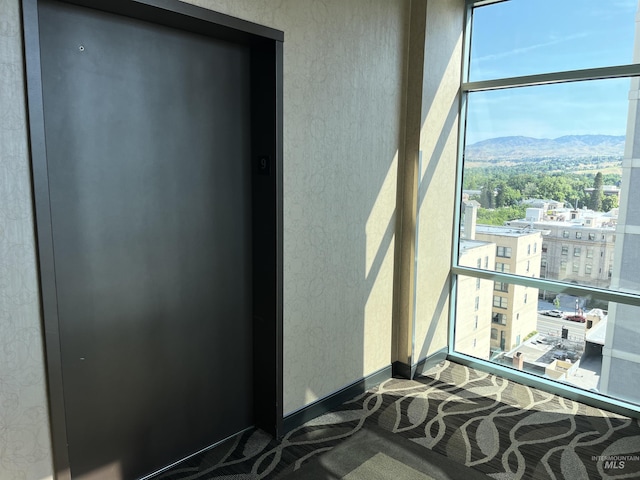 199 N Capitol Blvd, Boise, ID 83702 - view of exterior entry featuring elevator, a mountain view, and a balcony