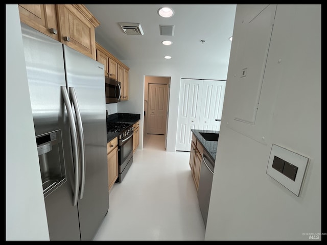 199 N Capitol Blvd, Boise, ID 83702 - kitchen with stainless steel appliances, dark stone countertops, recessed lighting, light brown cabinets, and concrete floors