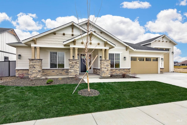 craftsman inspired home with a garage, stone siding, a front yard, and driveway