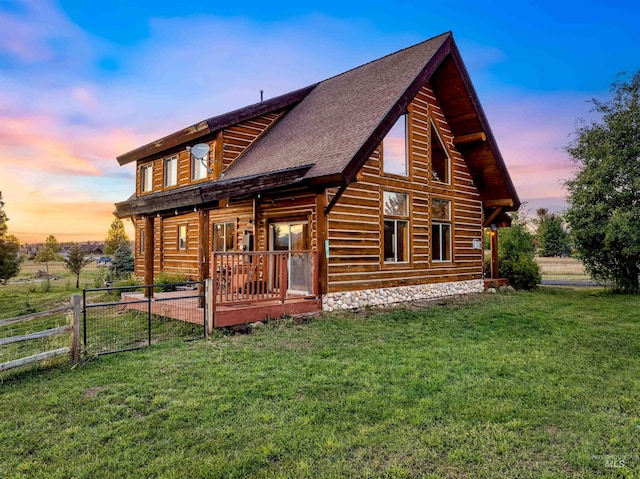 back house at dusk with a yard