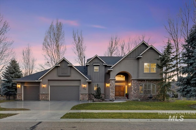 view of front of property featuring stone siding, board and batten siding, concrete driveway, and a garage