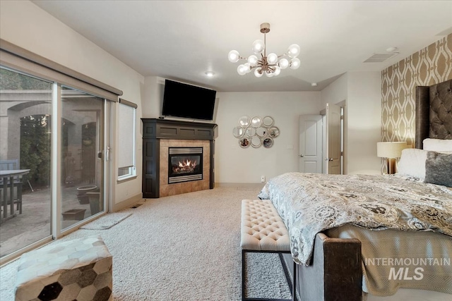 bedroom featuring access to exterior, visible vents, wallpapered walls, light colored carpet, and a tile fireplace