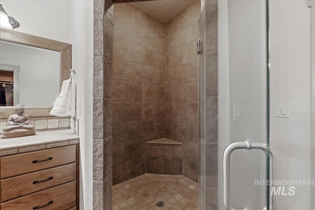 bathroom featuring a stall shower and vanity