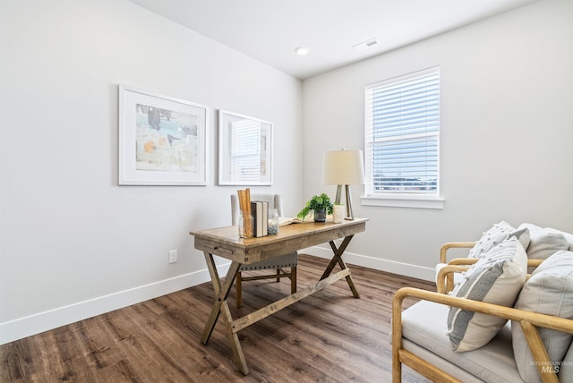 office featuring visible vents, baseboards, and wood finished floors