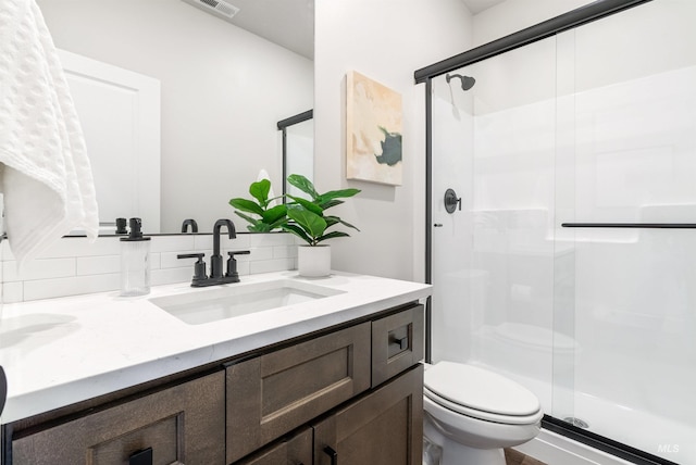 full bath featuring a stall shower, toilet, and vanity