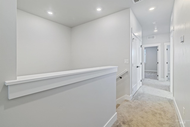 corridor featuring carpet flooring, recessed lighting, baseboards, and visible vents