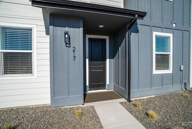 view of exterior entry with board and batten siding