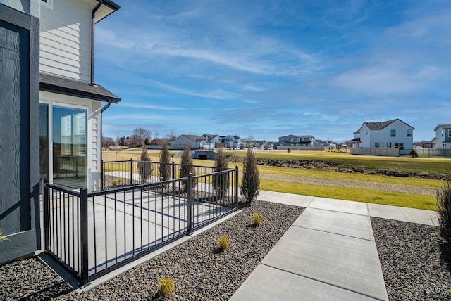 exterior space with a residential view, a patio, and fence