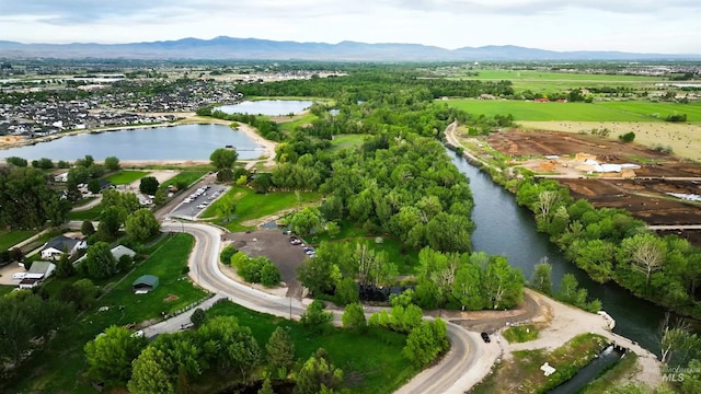 drone / aerial view with a water and mountain view