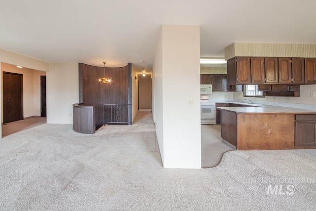2634 Laurel Ct, Clarkston, WA 99403 - kitchen featuring open floor plan, white appliances, light carpet, light countertops, and a sink