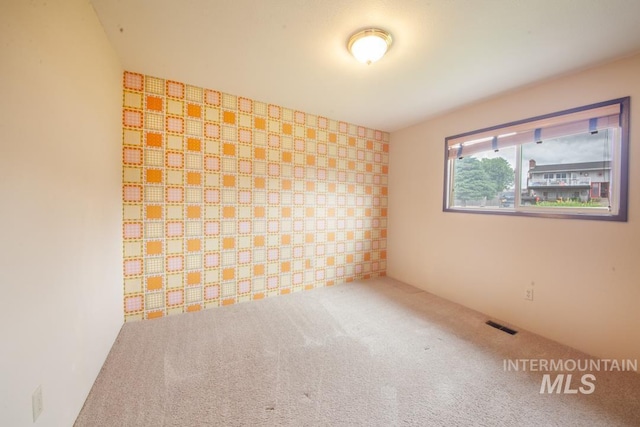 2634 Laurel Ct, Clarkston, WA 99403 - unfurnished room with an accent wall and carpet floors