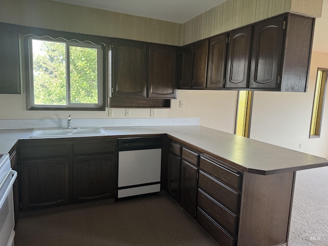 2634 Laurel Ct, Clarkston, WA 99403 - kitchen featuring dishwashing machine, a peninsula, a sink, dark brown cabinets, and light countertops