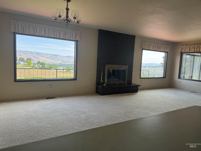 2634 Laurel Ct, Clarkston, WA 99403 - unfurnished living room featuring carpet, a chandelier, and a fireplace