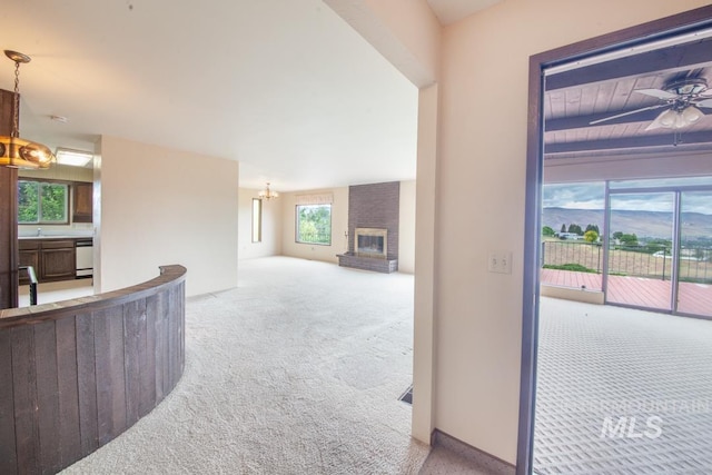 2634 Laurel Ct, Clarkston, WA 99403 - unfurnished living room with carpet, a brick fireplace, a chandelier, ceiling fan, and a sink