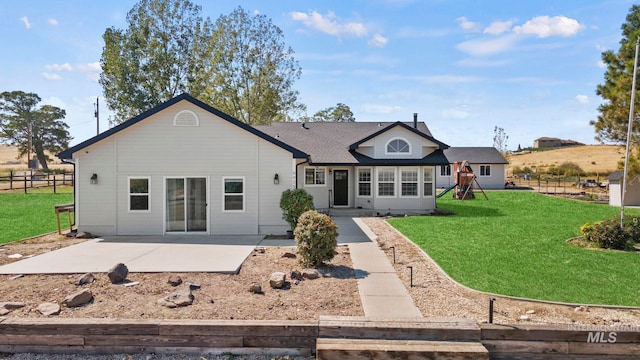 view of front of home with a front yard and a patio area