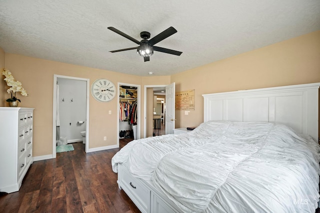 bedroom with a walk in closet, dark hardwood / wood-style flooring, a closet, ceiling fan, and ensuite bathroom