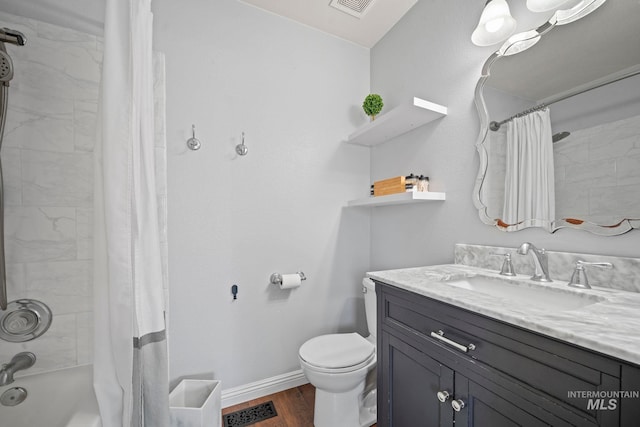 full bathroom featuring wood-type flooring, shower / bath combo with shower curtain, toilet, and vanity