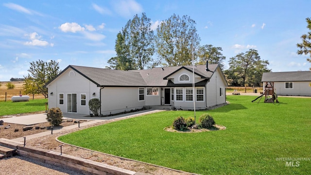 view of front of property featuring a front yard and a playground