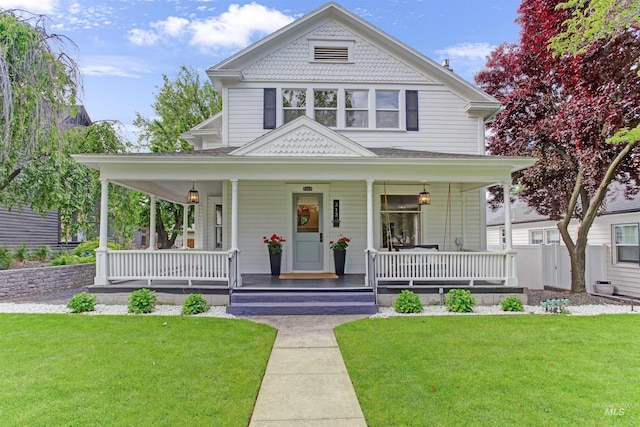 312 4th Ave, Lewiston, ID 83501 - victorian-style house featuring covered porch, a front yard, and roof with shingles