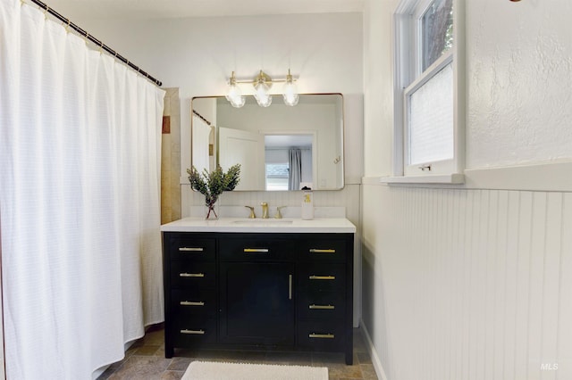 312 4th Ave, Lewiston, ID 83501 - bathroom featuring wainscoting, vanity, and curtained shower