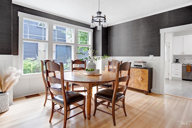 312 4th Ave, Lewiston, ID 83501 - dining space with healthy amount of natural light, light wood finished floors, a chandelier, and ornamental molding