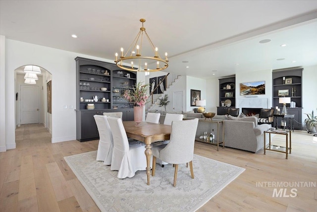 8 River Run Ests, Burley, ID 83318 - dining space featuring stairway, arched walkways, a chandelier, light wood finished floors, and recessed lighting