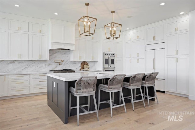 8 River Run Ests, Burley, ID 83318 - kitchen with paneled fridge, recessed lighting, white cabinetry, decorative backsplash, and a center island