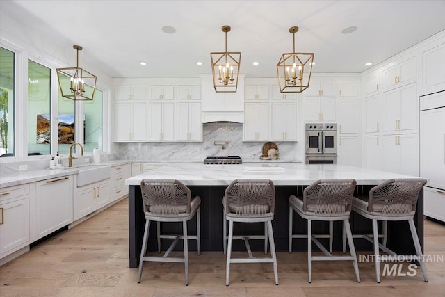 8 River Run Ests, Burley, ID 83318 - kitchen featuring a chandelier, a sink, double oven, white cabinets, and backsplash