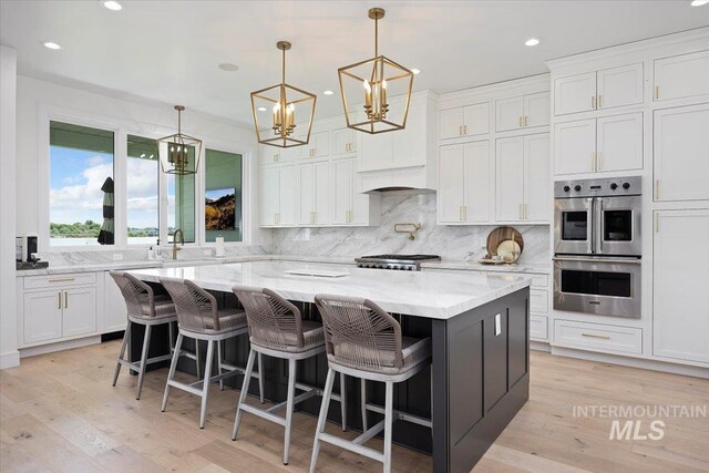 8 River Run Ests, Burley, ID 83318 - kitchen with double oven, a center island, white cabinets, decorative backsplash, and recessed lighting