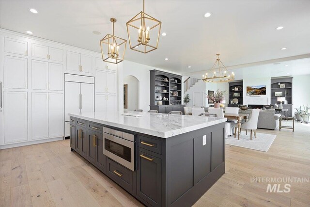 8 River Run Ests, Burley, ID 83318 - kitchen with a chandelier, built in appliances, white cabinetry, open floor plan, and recessed lighting