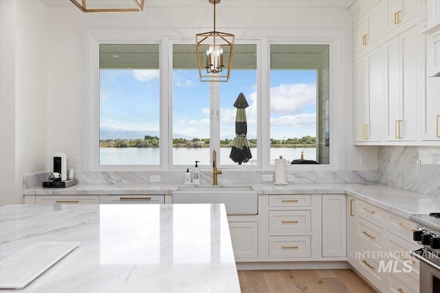 8 River Run Ests, Burley, ID 83318 - kitchen with a sink, white cabinetry, light stone counters, decorative light fixtures, and a chandelier