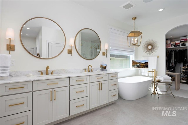 8 River Run Ests, Burley, ID 83318 - bathroom featuring double vanity, a freestanding bath, recessed lighting, and a shower