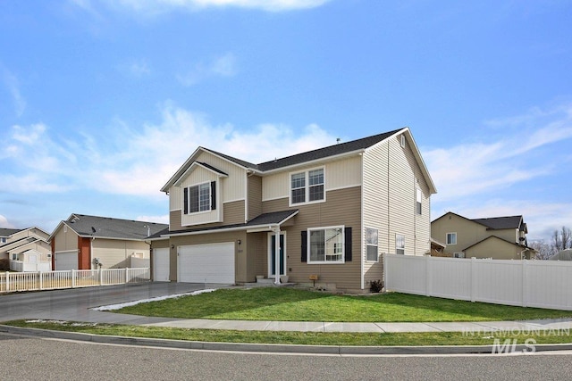 view of front of property with a garage and a front lawn