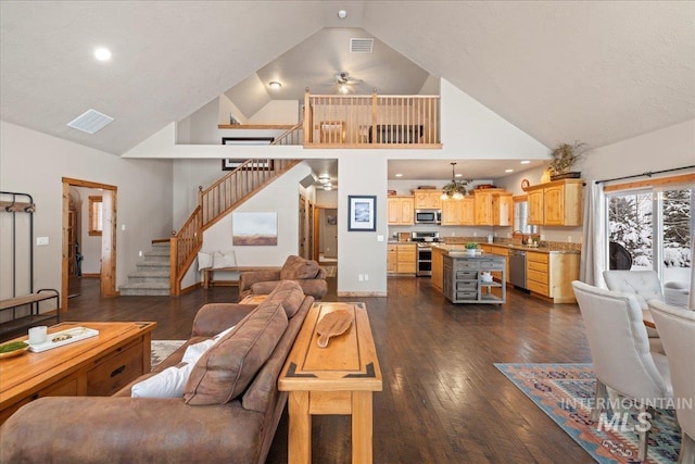 living room featuring ceiling fan, sink, high vaulted ceiling, and dark wood-type flooring