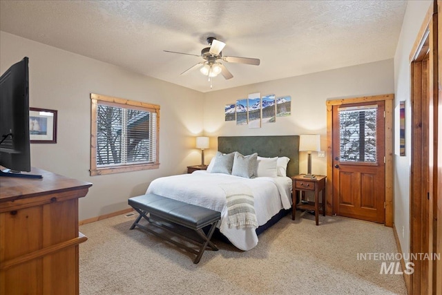 bedroom with carpet, a textured ceiling, and ceiling fan