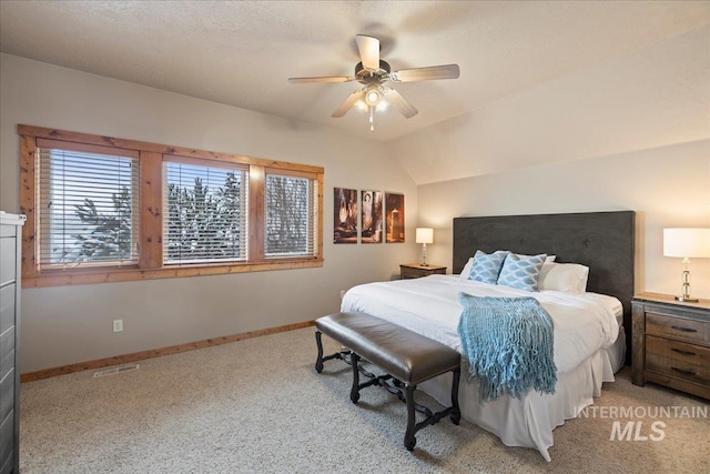 carpeted bedroom with ceiling fan and lofted ceiling