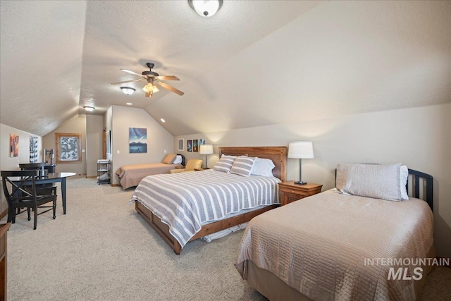 carpeted bedroom with a textured ceiling, ceiling fan, and lofted ceiling