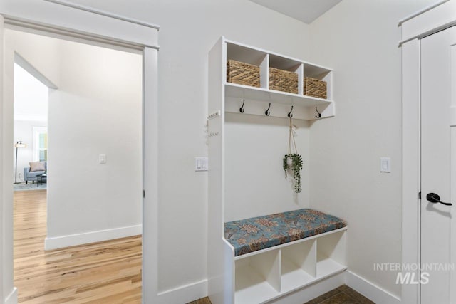 mudroom with baseboards and wood finished floors