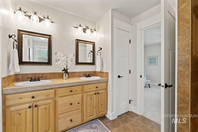 bathroom featuring double vanity and tile patterned floors
