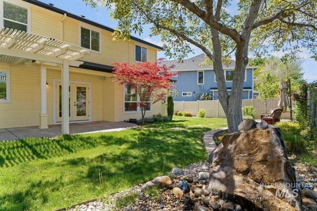 back of house with a pergola and a patio area