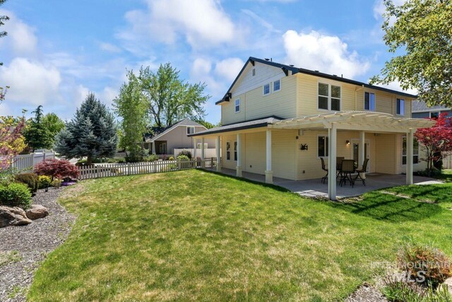 rear view of property with a pergola and a patio