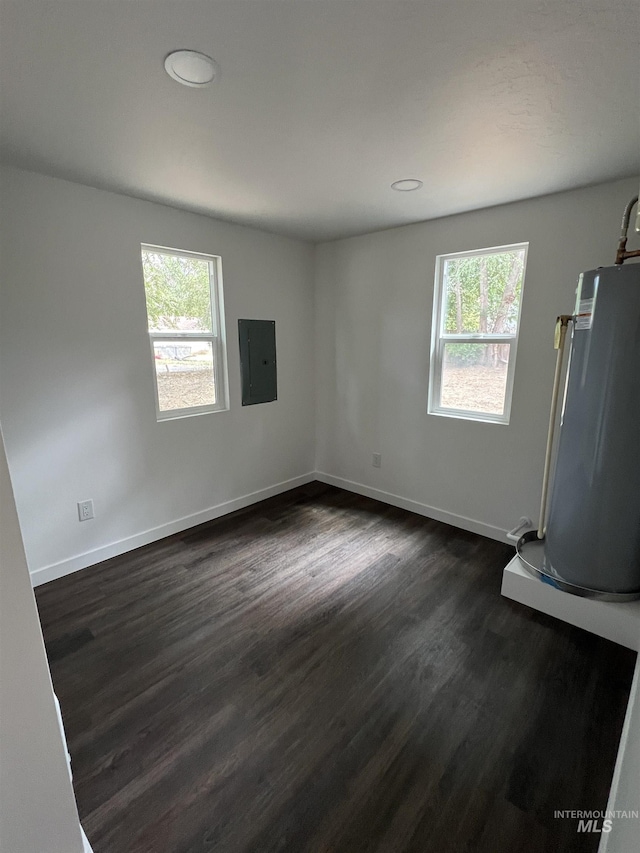 956 8th Ave N, Payette, ID 83661 - spare room with water heater, healthy amount of natural light, dark wood finished floors, electric panel, and recessed lighting