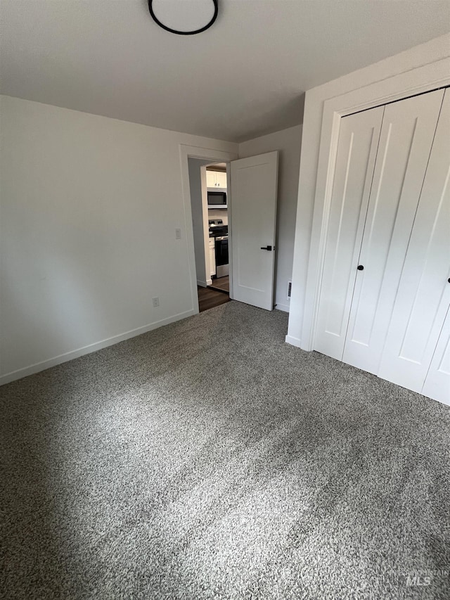 956 8th Ave N, Payette, ID 83661 - unfurnished bedroom featuring a closet and dark colored carpet
