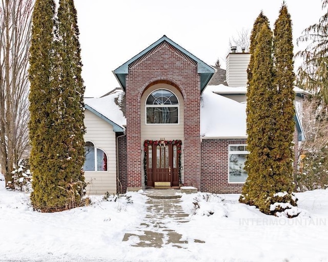 traditional-style house featuring brick siding