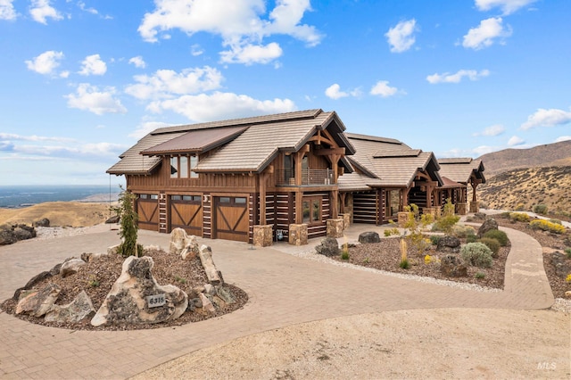 log home featuring a mountain view and a garage