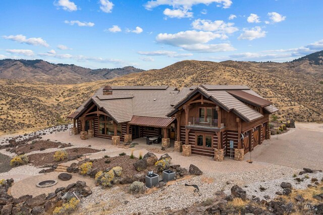 back of property with central AC unit and a mountain view