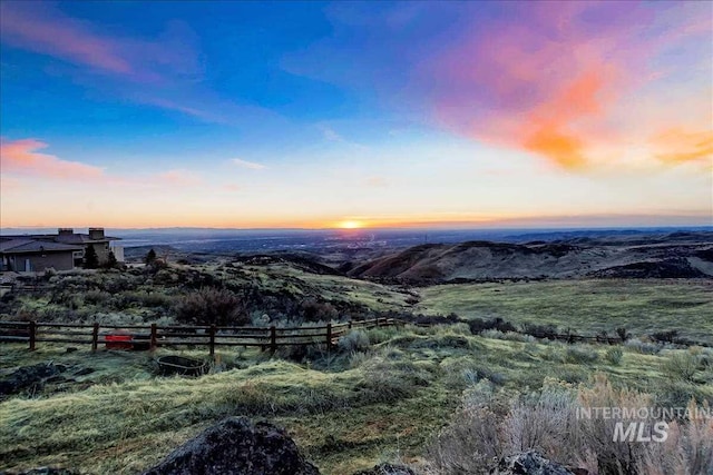 aerial view at dusk featuring a rural view