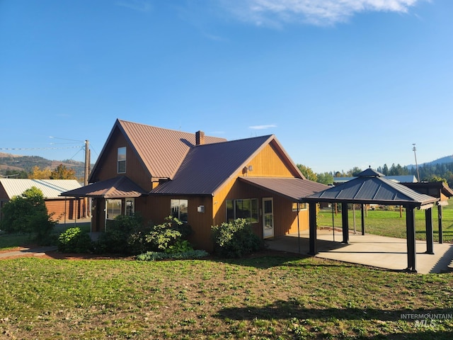 view of home's exterior featuring a gazebo, a yard, and a patio area